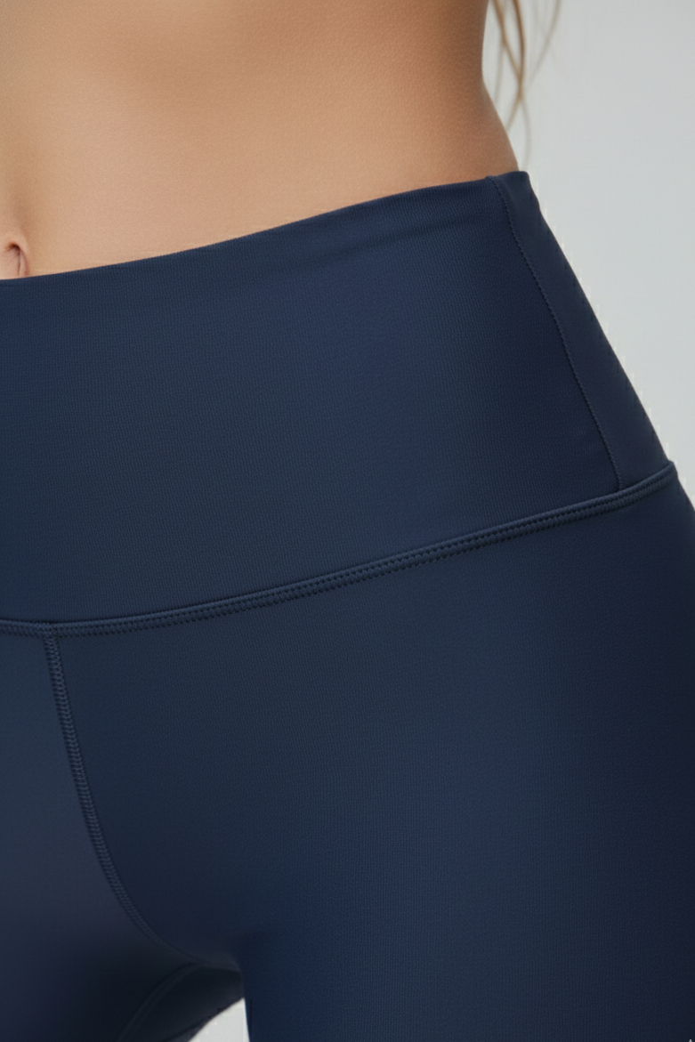 Navy blue leggings worn by a person on a plain background